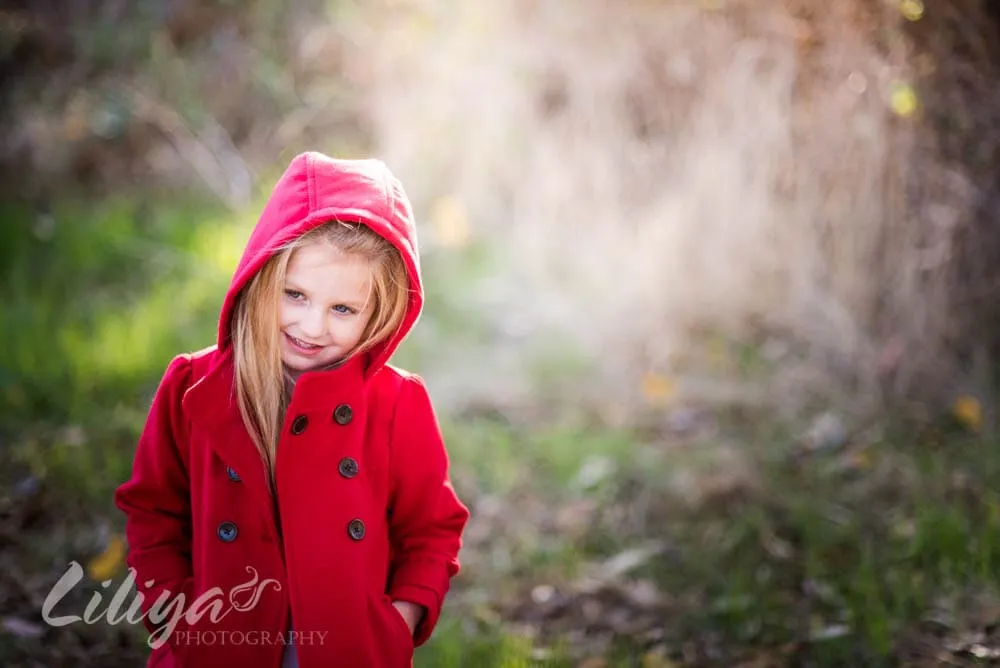 Young girl in a red hooded coat