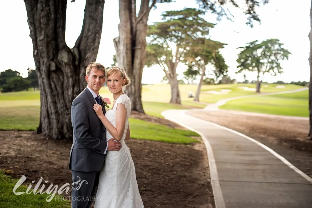 Bride and groom on a path across the golf course