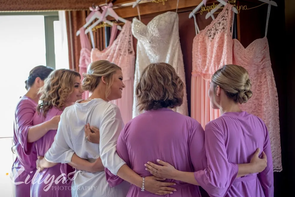 Bridesmaids in lilac, arm in arm