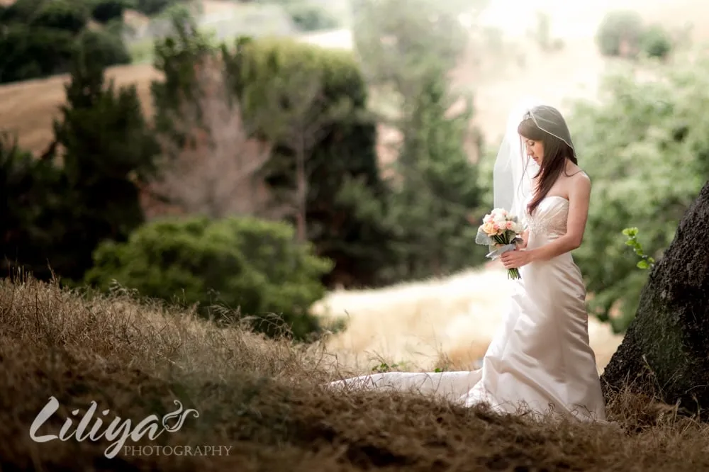 Bride holding her bouquet in an open field