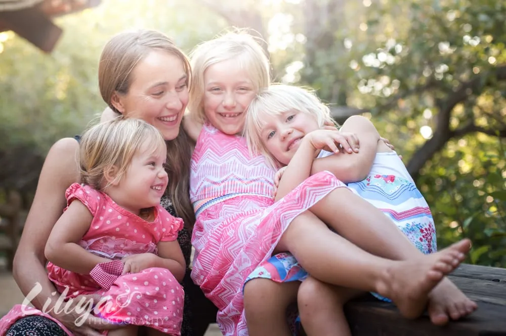 Mother and her three children together on the rocks