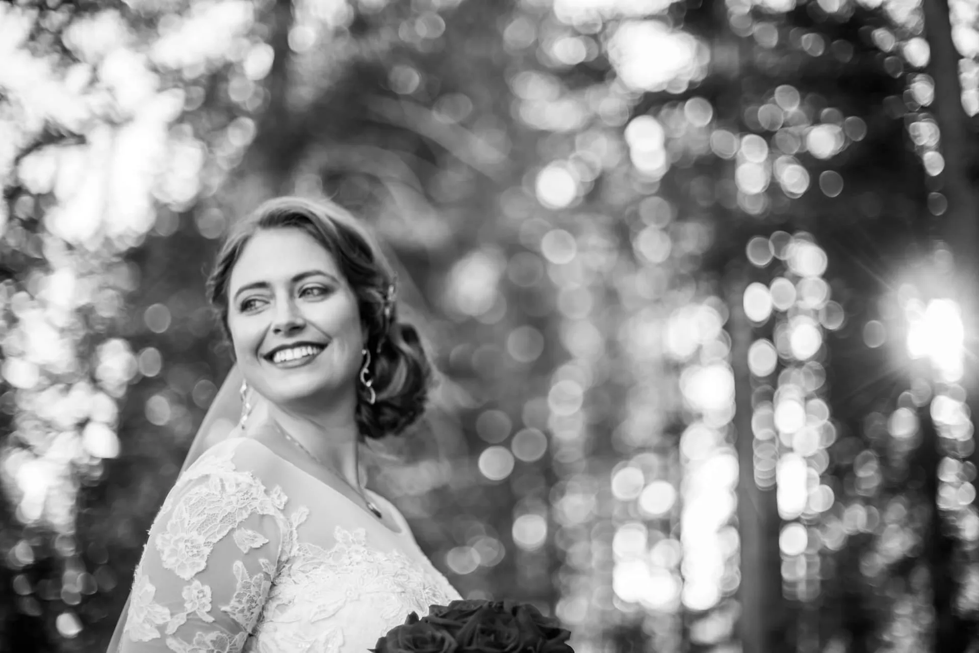 Black and white bridal portrait among the trees