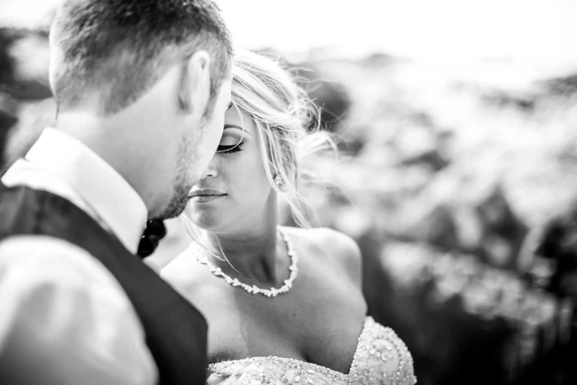 Bride and groom forehead to forehead, black and white